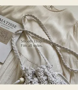 Detailed close-up of woven cotton rope texture with cream wooden bead drawstring