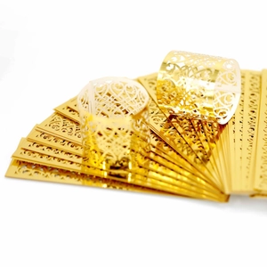 Elegant gold laser-cut filigree napkin rings for weddings and formal dining parties