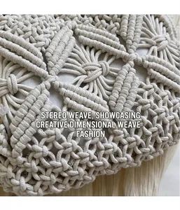 Detailed macro view of the intricate beige macramé hand-woven bohemian pattern texture
