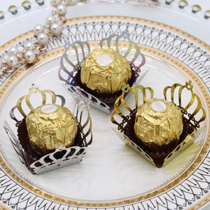 Detailed laser-cut crown chocolate wrappers in gold and silver mirror paper finish