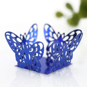 Intricate laser-cut blue butterfly lace cupcake wrappers with metallic finish