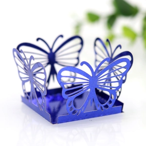Macro shot of electric blue laser-cut butterfly wedding favors box with mirror reflection