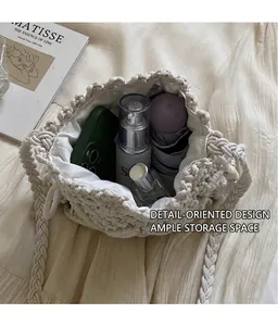 Detail of white woven bucket bag showing spacious interior with drawstring lining