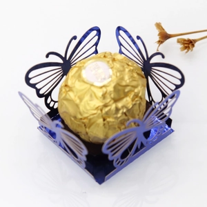 Close-up of laser-cut butterfly hollow chocolate liner in deep blue pearlescent paper