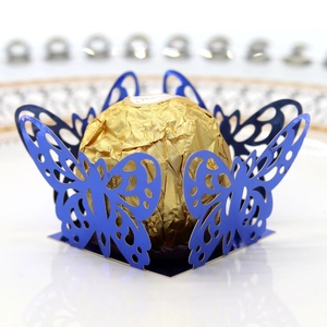 Close-up of laser-cut butterfly hollow candy box in navy blue for wedding table decor