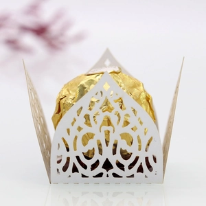 Macro view of white laser-cut hollow chocolate paper holder for weddings and parties