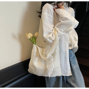 Détail d'un sac cabas en crochet blanc avec bordure en dentelle et texture tricotée