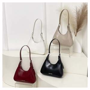 Detail of four colorful hobo bags in glossy leather with Fashion & Bags printed text