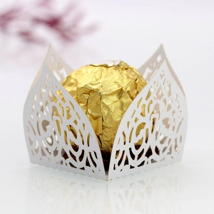 Macro detail of laser-cut white favor box with floral patterns for chocolates