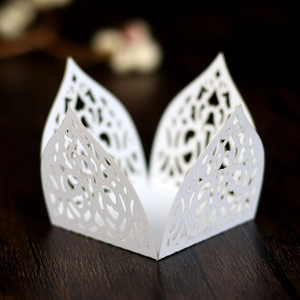 Detail of white laser-cut floral lace paper holder for cupcakes and chocolates