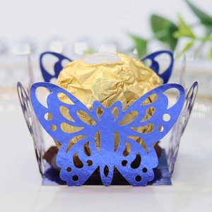 Macro detail of royal blue laser-cut butterfly wedding favor box with pearlescent finish