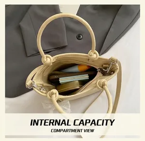 Internal capacity of beige pleated bucket bag showing phone and cosmetics layout