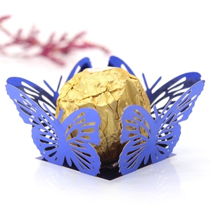 Close-up of laser-cut blue butterfly chocolate holder for wedding party favors