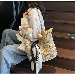 Chic beige woven straw tote bag with brown leather strap and decorative silk scarf detail