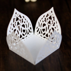 Detailed laser cut lace design of a white paper candy box for wedding party decoration