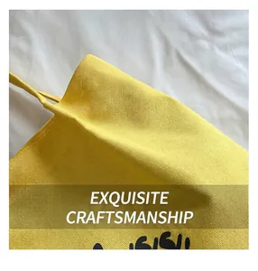 Detailed close-up showing the high-quality stitching and texture of the yellow canvas tote bag