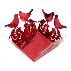 Detail of red laser-cut candy box featuring elegant bird silhouettes and floral patterns