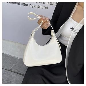 Detail of cream-white crescent shoulder bag with silver metal buckle and embossed logo
