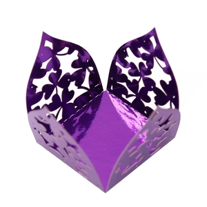 Macro shot of laser-cut clover pattern on purple metallic mirror finish gift box