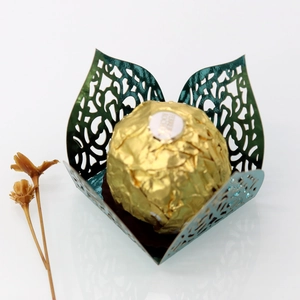 Detailed laser-cut dark green metallic paper candy wrapper with flower petal design