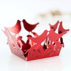 Detailed laser-cut wedding cupcake wrappers with romantic birds and red pearl finish