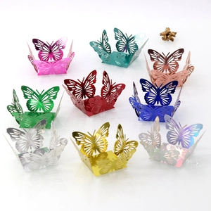 Close-up of laser cut butterfly candy boxes in nine metallic colors for wedding party decor
