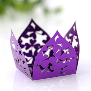 Detail of purple laser-cut cupcake wrapper with clover patterns for party favors