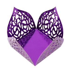 Macro detail of purple mirror finish chocolate box with laser cut floral vine patterns