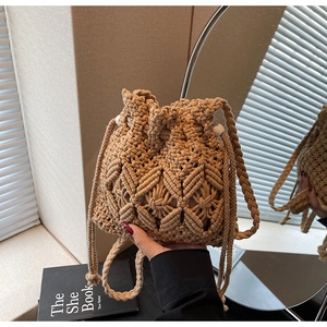 Close-up of bohemian hand-woven cotton rope bucket bag with diamond texture and drawstring
