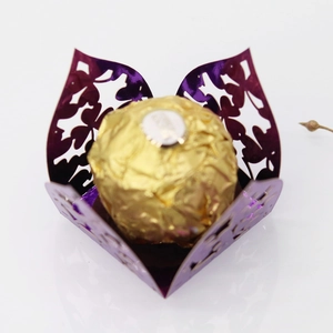 Macro detail of laser-cut purple clover candy box with intricate floral lace texture