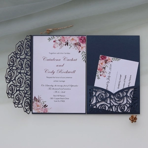 Detail of laser-cut rose navy blue wedding invitation with floral inner card and RSVP card