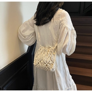 Detail of bohemian macrame bucket bag with intricate woven texture and wooden beads