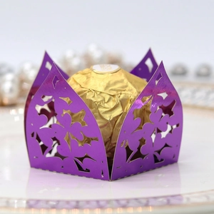 Macro shot of purple laser-cut candy box with elegant floral hollow pattern and pearlescent finish