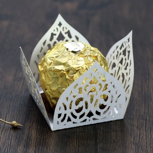 Macro detail of laser-cut hollow lace chocolate candy box with floral patterns