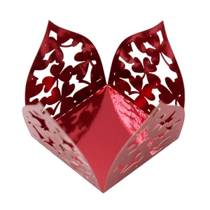 Detail of red hollow laser-cut clover candy box with glossy metallic finish for parties