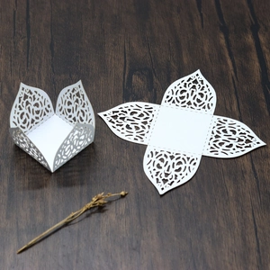 Detailed laser-cut white paper candy box showing flat layout and assembled 3D structure