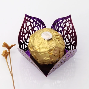 Detail of purple laser-cut pearl paper candy box with intricate floral hollow pattern