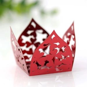 Close-up of laser-cut red paper candy box with intricate clover hollow pattern