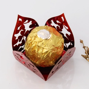 Close-up of red laser-cut chocolate gift box with heart pattern and mirror finish