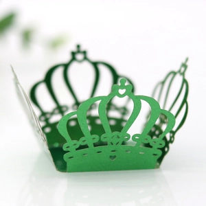 Detailed laser-cut crown cupcake wrapper in green paper with heart patterns
