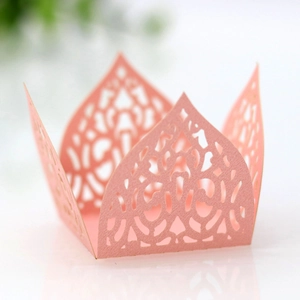 Macro detail of laser-cut pink paper candy box with intricate floral hollow design