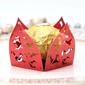 Macro detail of laser-cut red pearlescent cardstock gift box with floral patterns