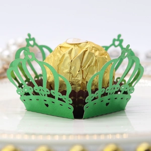 Close-up of green laser-cut crown candy box with hollow details for parties