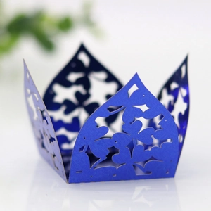 Detailed laser-cut hollow crown in dark blue paper for party cupcakes and wedding favors