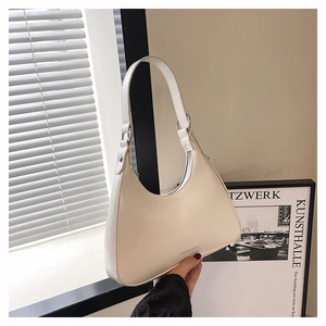 Close-up of cream white Hobo underarm bag with silver metal ring and smooth faux leather