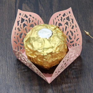 Macro detail of pink laser-cut lace candy wrapper with intricate floral patterns