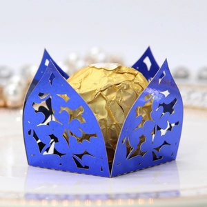 Detailed laser-cut blue clover pattern chocolate gift box with a golden candy inside