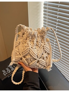 Handmade cream macramé drawstring bucket bag with geometric texture and wooden beads