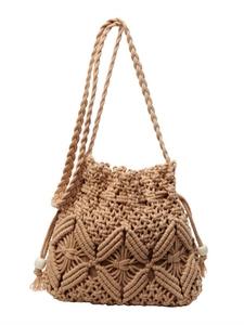 Handcrafted khaki woven bucket bag with tassels and geometric bohemian patterns
