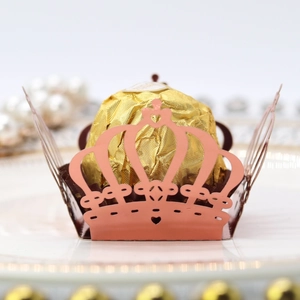 Macro detail of laser cut crown candy box with hollow lace pattern for party favors